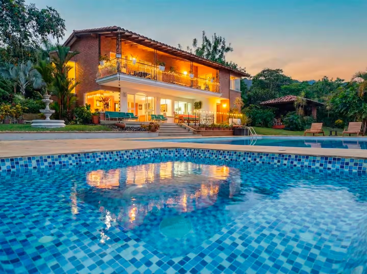 Main lodge exterior with pool at dusk